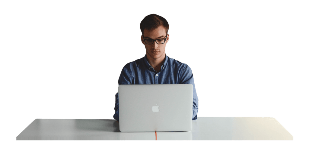 Picture of a young worker sitting in front of his Macbook.